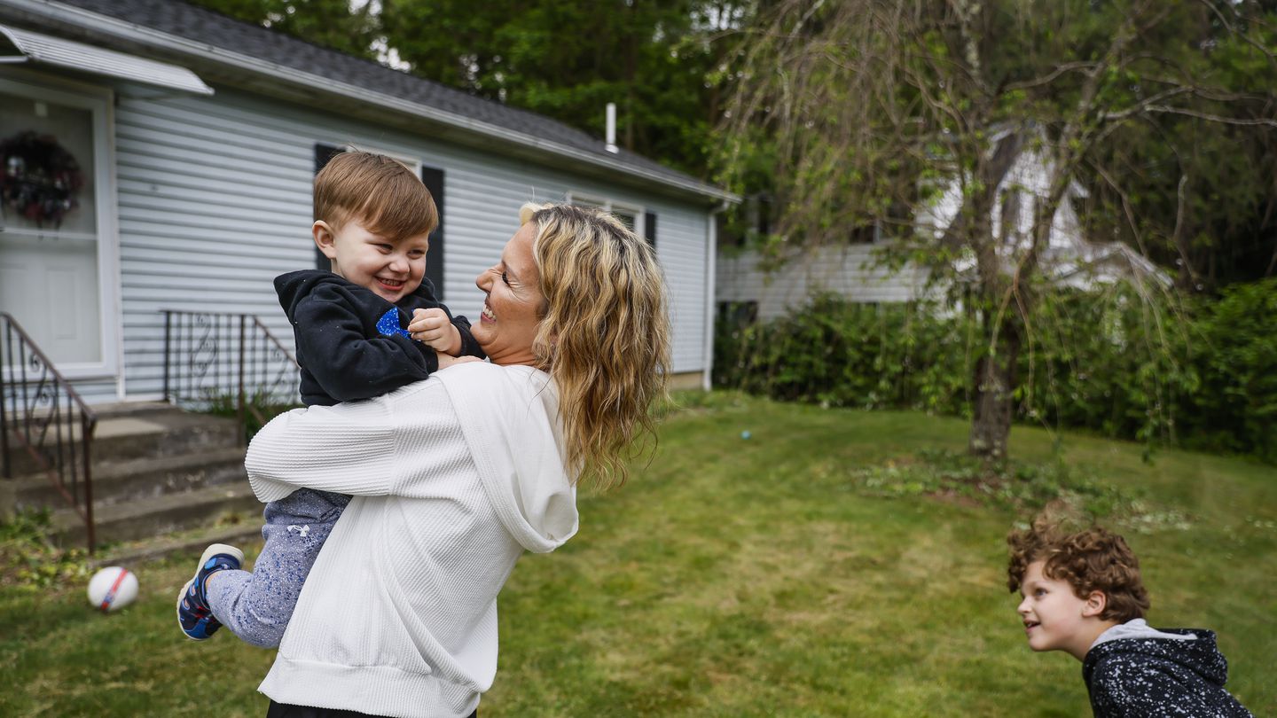 Kayla Ford hugged her son, Memphis, while playing in their front yard with her three sons. Ford was in recovery and taking Suboxone when she was reported to the Department of Children and Families following the birth of each of her children.